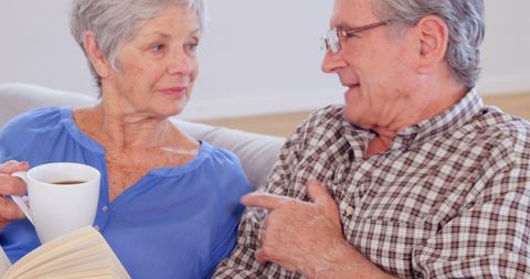 Elderly Couple Sharing Warm Moment with Coffee and Book - Download Free Stock Images Pikwizard.com