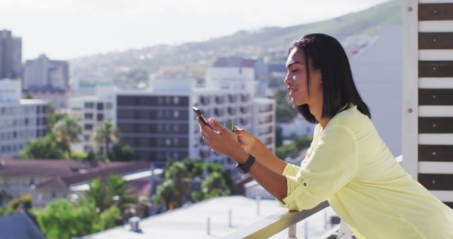 Young Woman Texting on Balcony with Cityscape Background - Download Free Stock Images Pikwizard.com