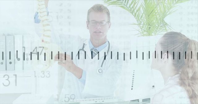 Doctor demonstrates spine model to patient in clinic