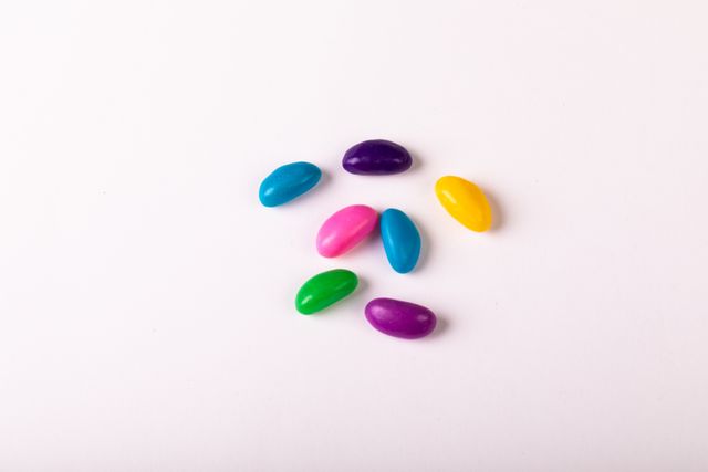 Directly above shot of colorful candies on white background, copy space. unaltered, sweet food, studio shot and indulgence.