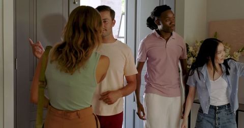 Friends Socializing in Home Entryway Inviting Atmosphere