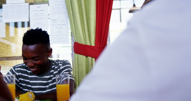 Smiling Young Man Enjoying Meal at Restaurant - Download Free Stock Images Pikwizard.com