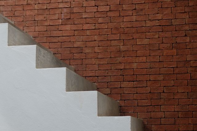Modern Staircase against Exposed Red Brick Wall - Download Free Stock Photos Pikwizard.com