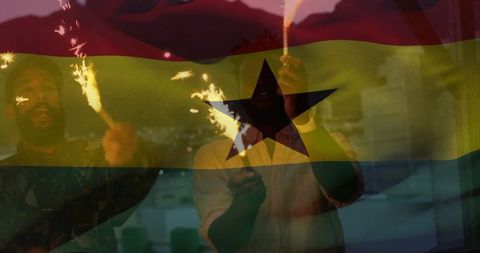 Ghanaian friends celebrating with sparklers on balcony at dusk, lights, festive sparks