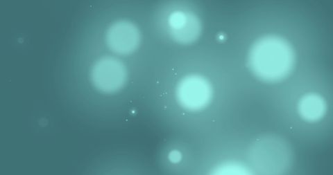 Glowing green abstract light spots on blurred background