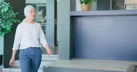 Thoughtful Woman Standing in Modern Residential Space