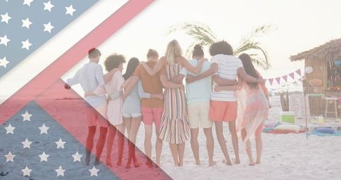 Young friends standing arm in arm on tropical beach at sunset with american flag overlay