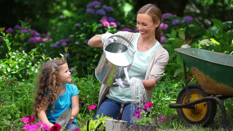 Mother and Daughter Enjoy Sunny Day in Garden
