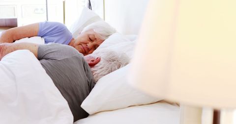 Senior Couple Peacefully Sleeping in Cozy Bedroom