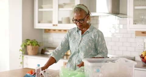 Senior woman engaged in responsible recycling at home