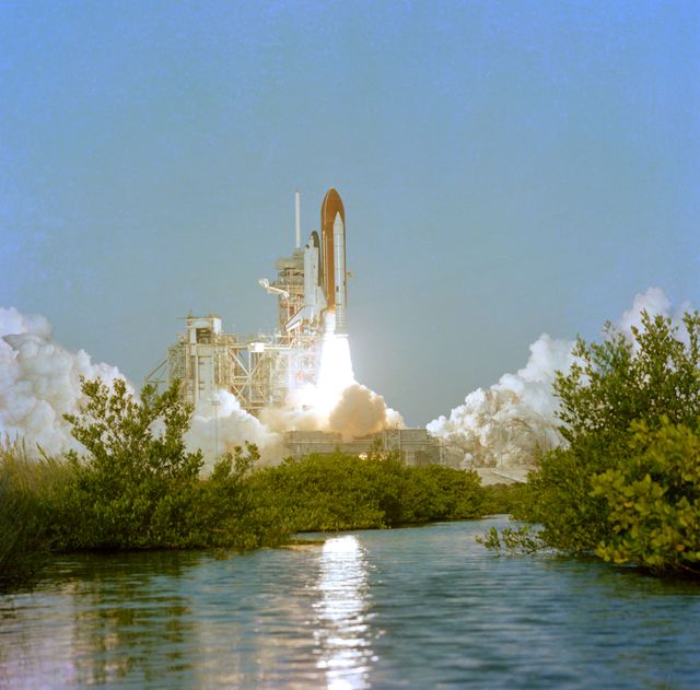 Columbia Space Shuttle launching at Kennedy Space Center on November 11, 1982. Image shows the shuttle clearing the launch tower with clouds of smoke and flames released from the boosters. Very significant for space exploration depictions, can be used for educational material related to space missions, or for invoking science and technology themes.