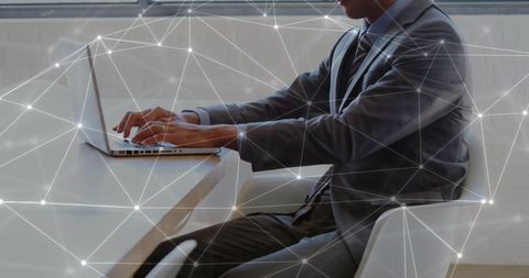 businessman analyzing data on laptop with abstract network overlay - Download Free Stock Images Pikwizard.com