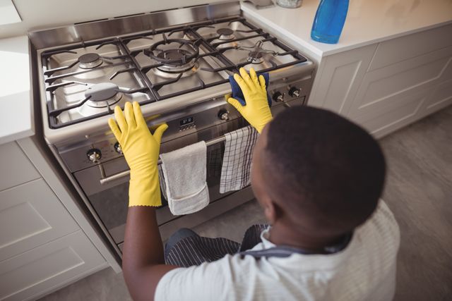 Man checking gas stove in kitchen at home