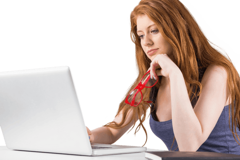Young Redhead Woman Focused on Laptop with Transparent Background