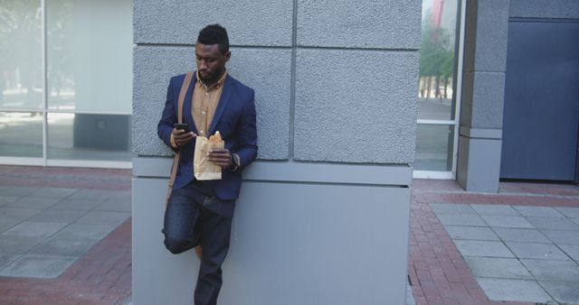 Businessman Scrolling Smartphone While Taking a Break Outside Office Building - Download Free Stock Images Pikwizard.com