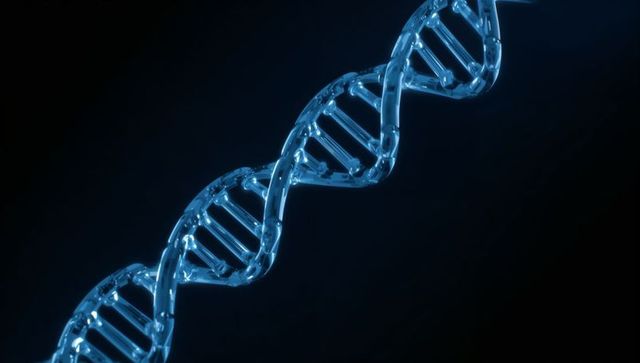 Glowing blue dna double helix spiraling diagonally over dark background, genetics concept