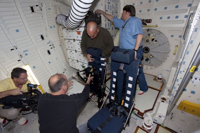 Technicians Working on Shuttle Discovery Middeck Seats in Orbiter Processing Facility - Download Free Stock Images Pikwizard.com