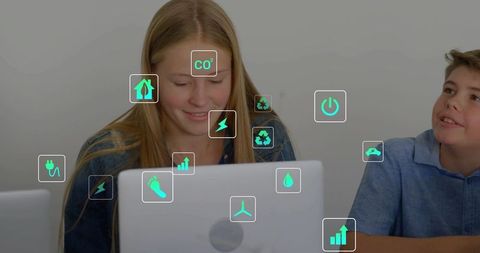 Teen typing on laptop with green sustainability icons showing energy, recycling and data