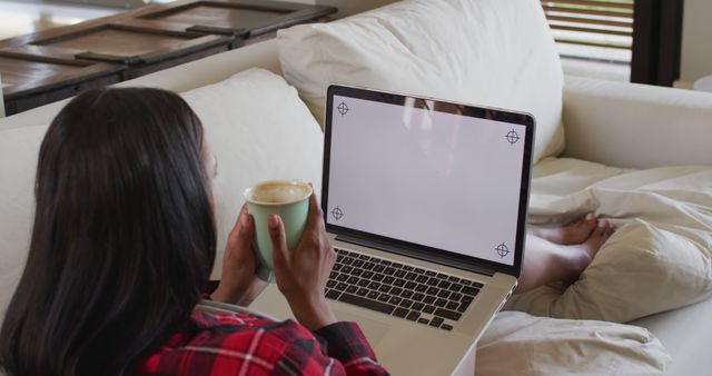 Woman Relaxing on Couch While Using Laptop and Drinking Coffee - Download Free Stock Images Pikwizard.com