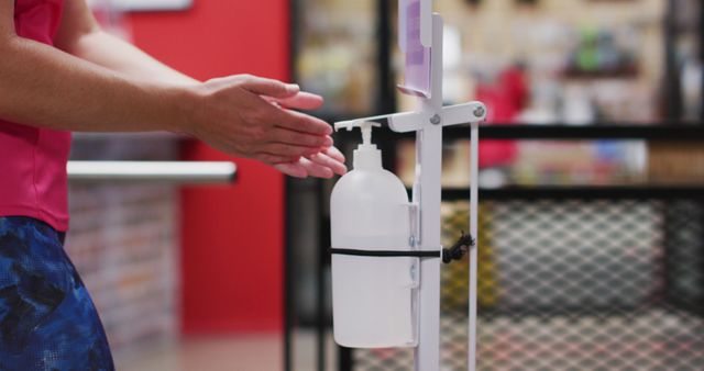 Person Using Hand Sanitizer Dispenser - Download Free Stock Images Pikwizard.com