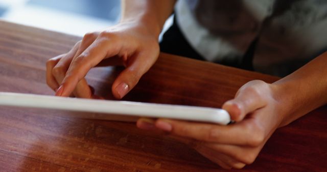 Hands Using Digital Tablet on Wooden Table - Download Free Stock Images Pikwizard.com