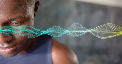 Gazing male athlete sweating and focusing with neon waveform overlay representing concentration