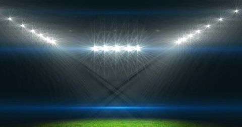 Dramatic Stadium Lighting on Green Field for Winning Moment