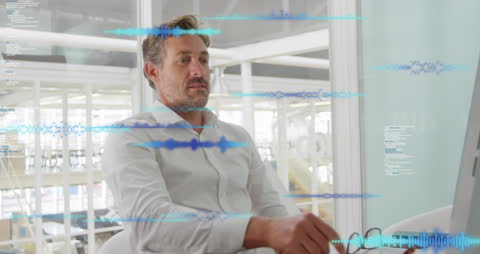 Businessman Analyzing Data on Computer in Modern Office