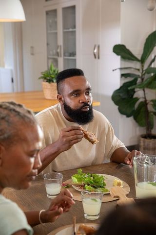 Family Enjoying a Meal Together in Cozy Kitchen Setting