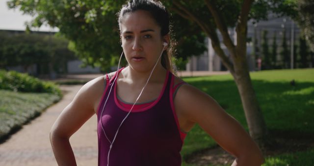 Fit Woman Wearing Earphones Taking Break During Outdoor Workout - Download Free Stock Images Pikwizard.com