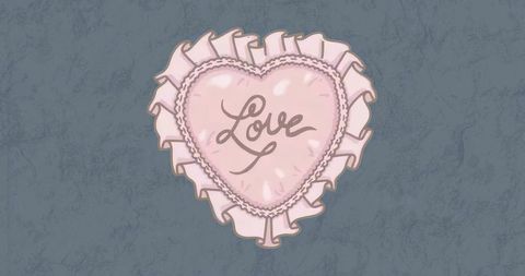 Pink heart-shaped love cushion with ruffled trim