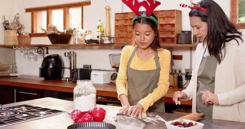 Mother and Daughter Baking Preparation for Christmas Festive Dessert