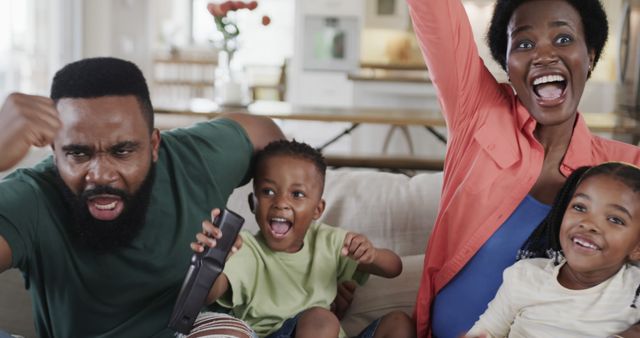 Excited Family Cheering While Watching Television Together on Couch - Download Free Stock Images Pikwizard.com