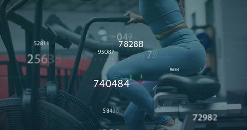 Fit Woman Cycling on Stationary Bike in Gym