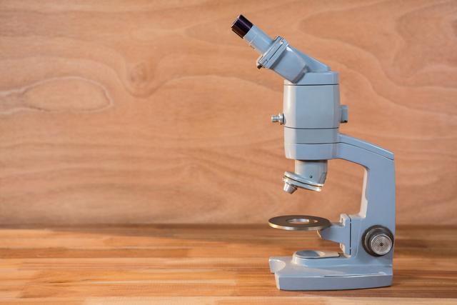 Close-up of microscope on a wooden table