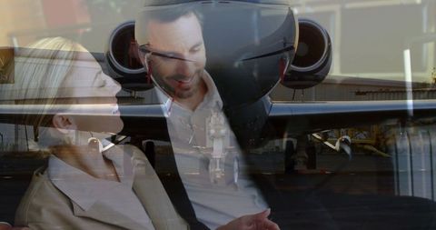 Colleagues networking in private jet airport lounge with tablet