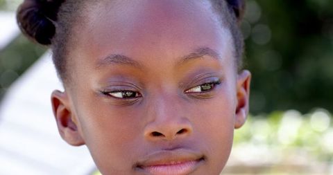 African american child outdoors in natural light with hair buns