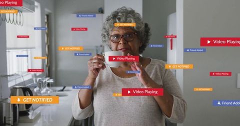 Elderly Woman Navigating Digital Notifications in Modern Kitchen