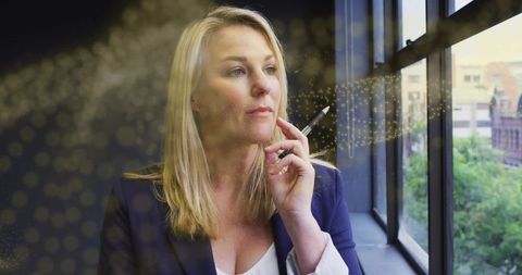 Businesswoman Contemplating Near Office Window with Golden Halo