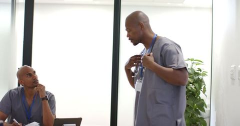 African american healthcare team discussing patient notes during clinic briefing