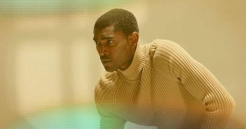 Introspective Vision: Man Leaning Dramatically in Soft-themed Studio