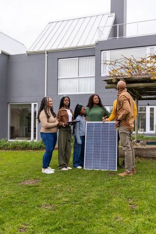 African american family discussing solar panel installation in modern home garden