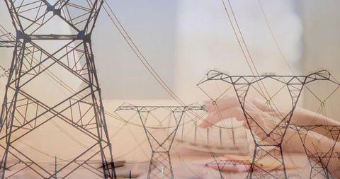 Overlaying transmission towers with hands writing technical notes for energy planning