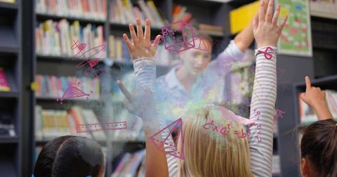 Elementary students raising hands in library classroom displaying interactive math on glass