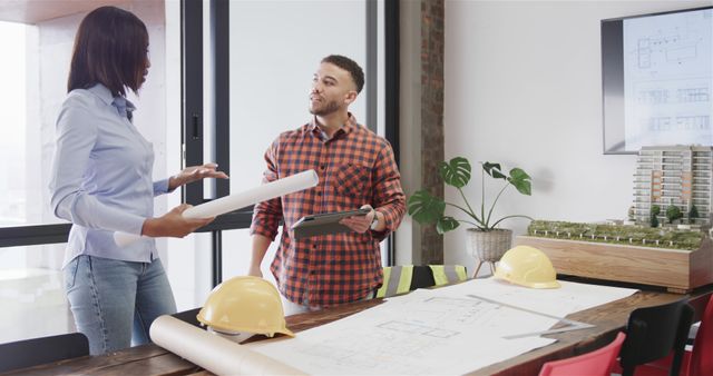 Architect Discussing Project Layout with Engineer in Office - Download Free Stock Images Pikwizard.com