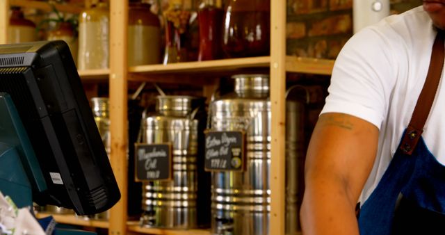 Barista Working at Coffee Shop Counter Near Industrial Coffee Canisters - Download Free Stock Images Pikwizard.com