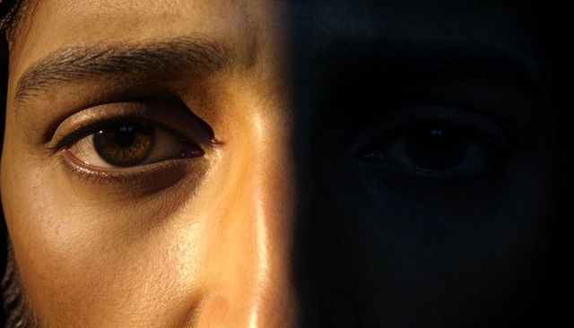 Moody split-lighting male face closeup high-contrast chiaroscuro portrait headshot