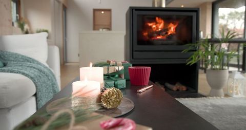 Warm Cozy Living Room with Burns Candles and Festive Gifts