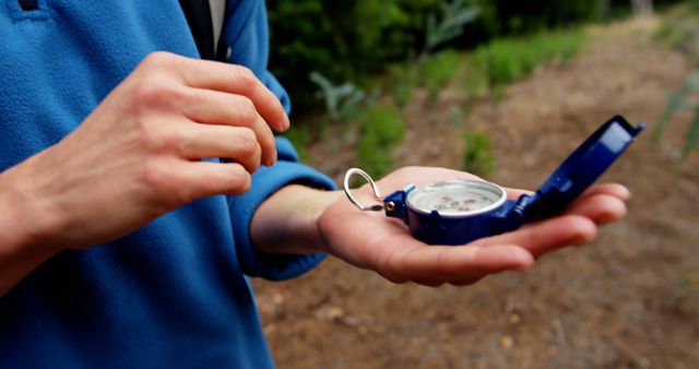 Person Using Compass for Navigation Outdoors - Download Free Stock Images Pikwizard.com