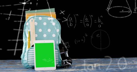 Backpack with Digital Tablet and Math Formulas on Blackboard